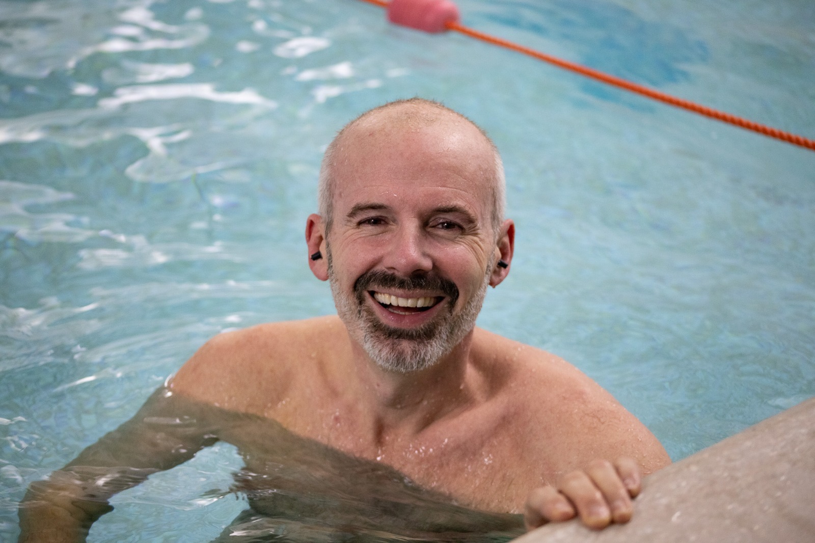 Teacher supporting a back float