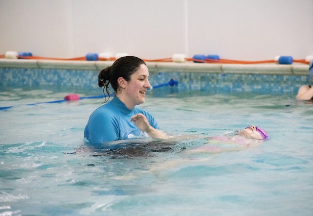Two swimmers laughing in the pool